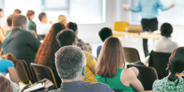 annual planning meeting attendees watching presentation